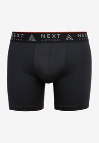 Boxer briefs attivi neri con design aderente, vita elasticizzata con branding bianco "NEXT ACTIVE" e texture liscia.