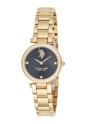 Goldfarbene Metallarmbanduhr mit schwarzem Zifferblatt, mit Kristallen besetzter Lünette, U.S. Polo Assn. Logo und drei Kristall-Stundenmarkierungen bei 3, 6 und 9 Uhr.