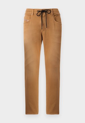Pantalons marron clair avec une texture douce, taille élastique à cordon de serrage et détails de poche à motifs. Conception à jambes droites avec coutures surpiquées.