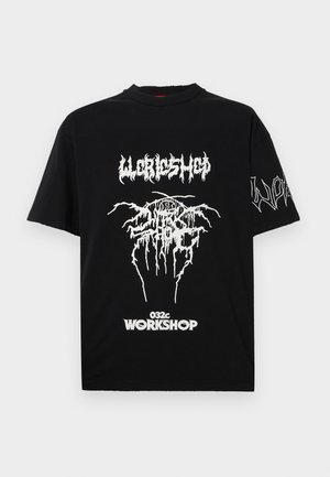 Black cotton t-shirt featuring bold white graphic prints, including the word "WORKSHOP" and abstract designs on the front and sleeve.