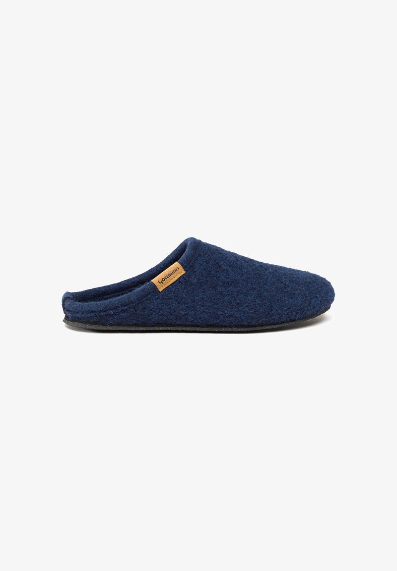 Marineblå slip-on uldslippers med sort sål og lille tanmærkat på siden mod hvid baggrund.