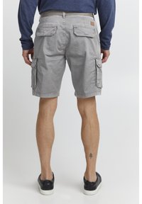 Gray cargo shorts with multiple pockets, a belt loop, and a relaxed fit. Made of cotton fabric with a smooth texture.