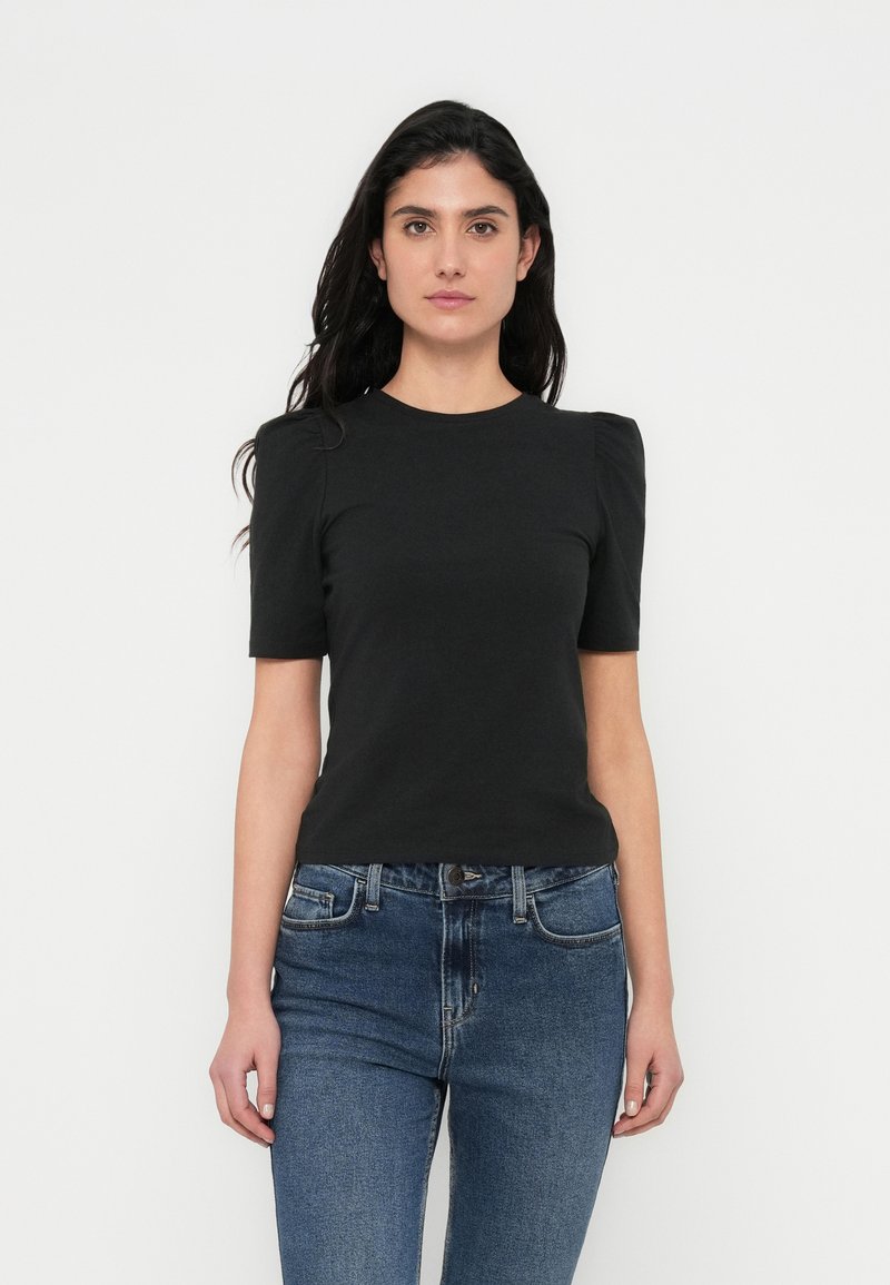 Zwart T-shirt met korte mouwen, een ronde hals en geplooide pofschouderdetails, gecombineerd met medium-wash denim jeans.