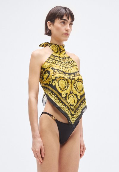 Zgornji del iz svilenega šala v črni in rumeni barvi z okrašenim cvetličnim vzorcem, zavezano okoli vratu. Kombinirano s črnimi bikini hlačkami z zlatimi poudarki.