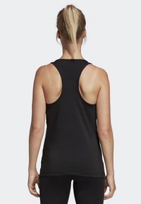 Black athletic tank top, featuring a racerback design and smooth fabric. The hem is slightly curved, enhancing flexibility and comfort.