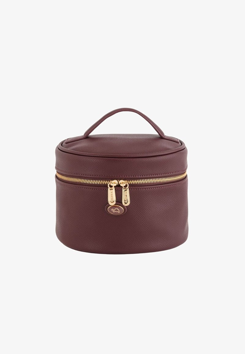 Round burgundy cosmetic bag with textured exterior, gold zipper closure, and a top handle for easy carrying. Elegant logo detail on front.