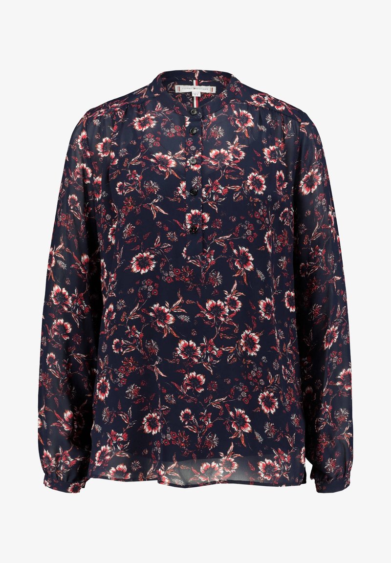 Blusa navy con maniche lunghe, motivo floreale in rosso e bianco, abbottonatura frontale, tessuto leggero con leggero lucido e consistenza morbida.