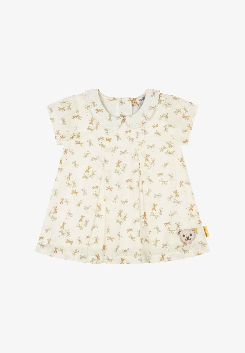 Světle zbarvené šaty s krátkým rukávem, s kulatým límcem a květinovým vzorem v oranžové a zelené, s aplikací medvěda na lemu.