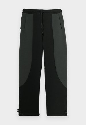 Zwarte en donkergrijze joggerbroeken met een trekkoord in de taille, zijzakken, een soepele textuur en een contrasterend paneelontwerp.