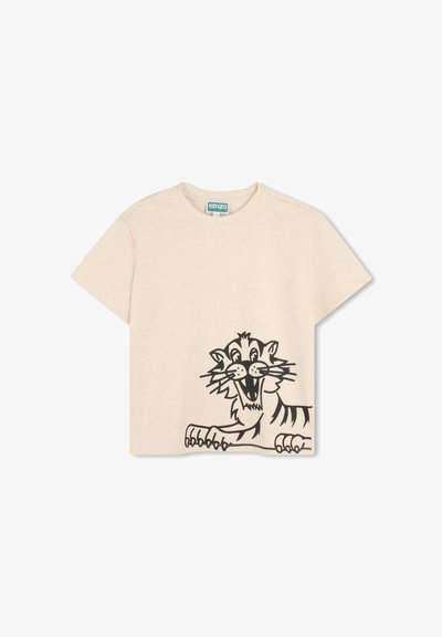 T-shirt en coton beige avec un grand graphisme de tigre noir sur le devant. Manches courtes et coupe décontractée avec un col rond.