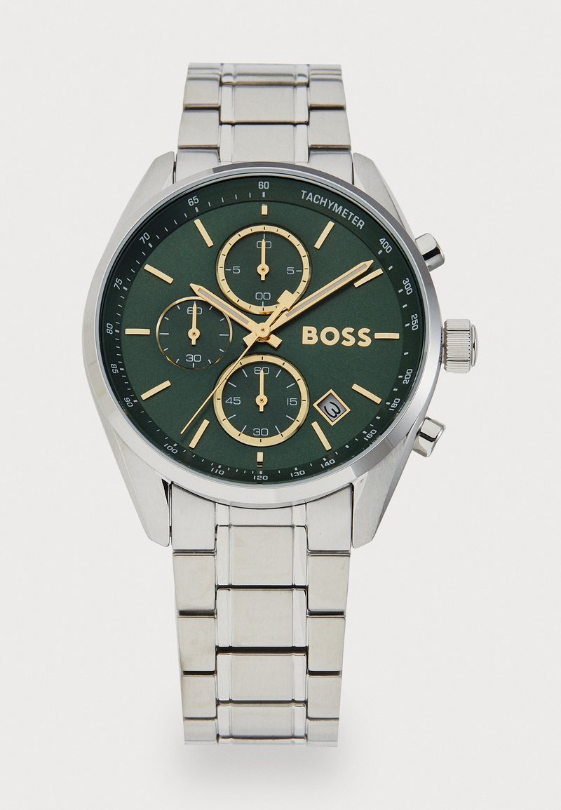 Stainless steel watch with a green dial, gold accents, tachymeter scale, and three sub-dials; rectangular links on the metal bracelet.