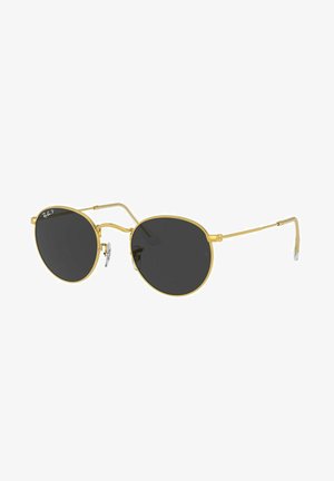 Occhiali da sole rotondi con montatura in metallo dorato, lenti nere e design slim. Presentano distintivi naselli e aste sottili.