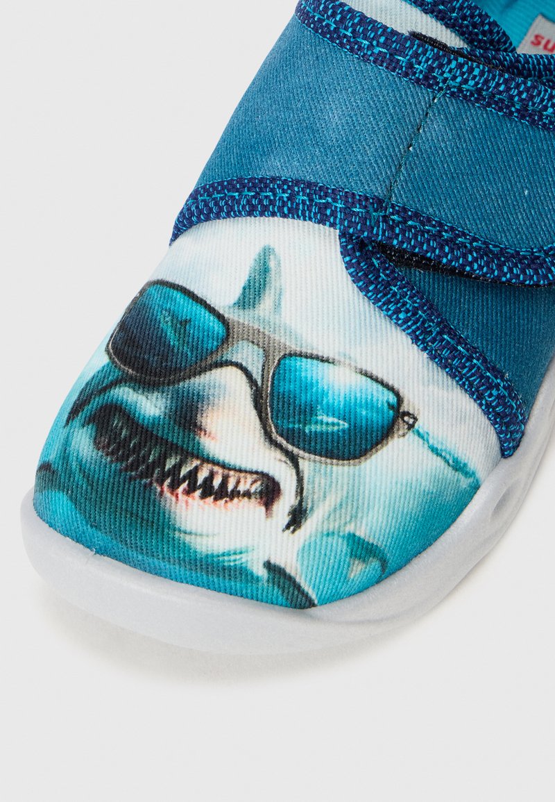Blaue Haifisch-Themen-Sandalen zeigen ein Design eines Hais, der Sonnenbrillen trägt, mit Klettverschlussriemen und einer weichen Gummisohle.