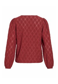 Blouse en dentelle bordeaux à manches longues avec épaules bouffantes et motif floral ajouré, vue de dos.