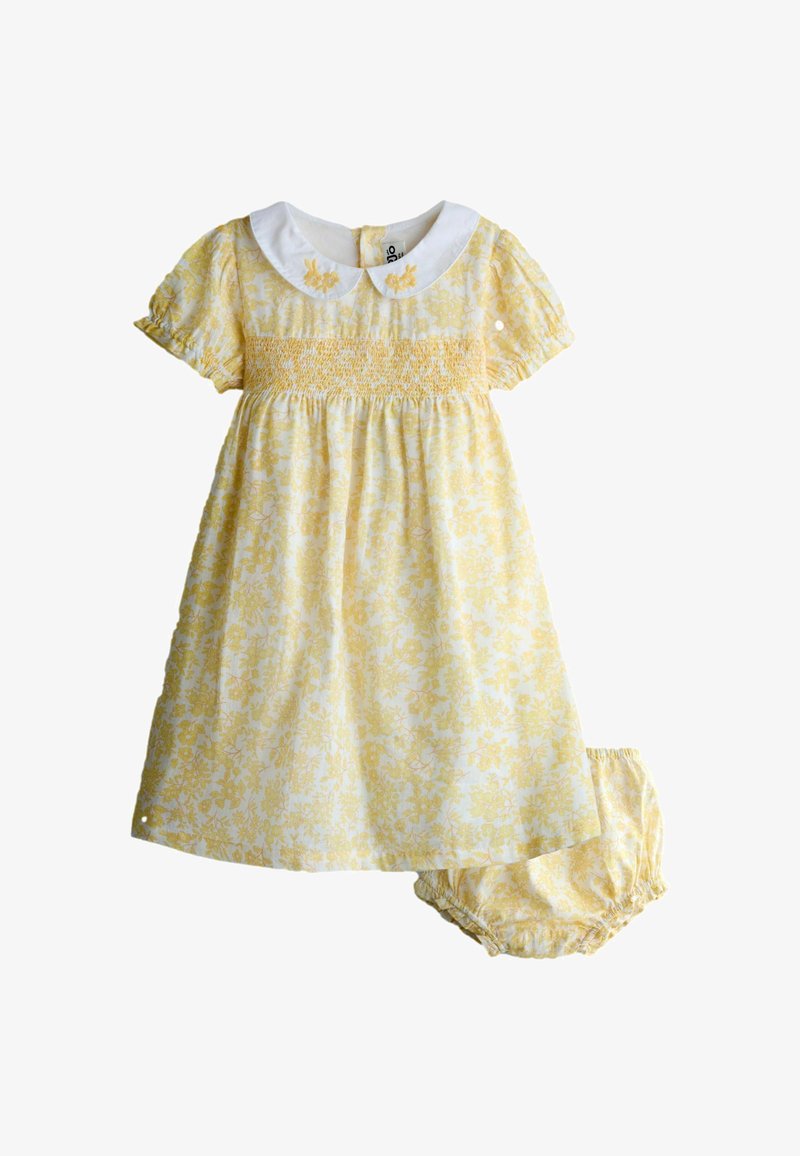 Vestido amarillo con flores para bebé, con cuello Peter Pan blanco y pololos a juego, mangas cortas abullonadas y cuerpo fruncido.