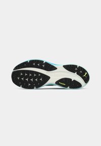Black rubber sole with a white midsole and turquoise accents; features a textured tread pattern for grip and 'PUMAGRIP' branding.
