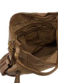 Tan leather handbag with a soft texture, featuring a spacious interior, multiple zippered pockets, and a metal hardware accent.