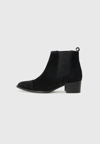 Black suede ankle boot with a block heel, elastic side panels, and a loop at the back for easy wear, set against a white background.