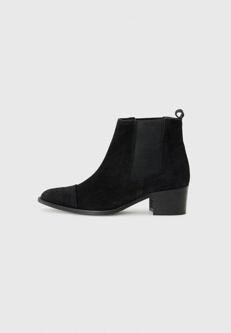 Black suede ankle boot with a block heel, elastic side panels, and a loop at the back for easy wear, set against a white background.