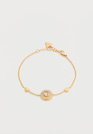 Zlata zapestnica s kroglo z dvema srčkoma in okroglim obeskom, okrašenim s kristali in osrednjim logotipom "G".