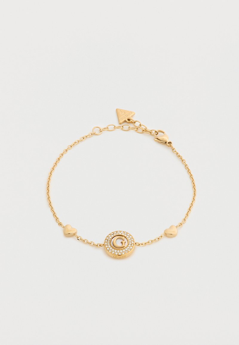 Βραχιόλι αλυσίδας από χρυσό με δύο μενταγιόν σε σχήμα καρδιάς και ένα κυκλικό μενταγιόν διακοσμημένο με κρυστάλλους και κεντρικό λογότυπο "G".