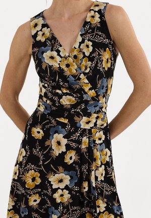 Sleeveless black dress with yellow, white, and blue floral pattern, featuring a V-neck and wrap-style bodice.