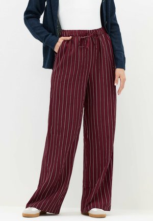 Burgundy wide-leg trousers with white vertical stripes, featuring an elastic waistband and drawstring, made from a soft fabric.