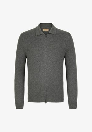 Szary kardigan zapinany na zamek, wykonany z miękkiej wełny, z kołnierzem, długimi rękawami i kieszenią na piersi. Posiada prążkowane mankiety i dół.