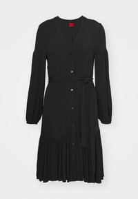 Black dress in lightweight fabric, featuring a V-neck, long sleeves, front buttons, a belted waist, and a flared ruffle hem.