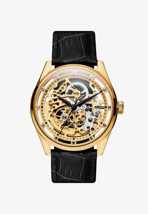 Skeletoruhr med et gullfarget rustfritt stålkasse, svart krokodillemønster lærrem, transparent klokke som avslører intrikate mekanismer.