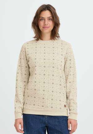 Felpa beige con un motivo geometrico marrone scuro, polsini e fondo a costine, e un piccolo logo in tessuto sul bordo inferiore.