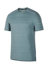 Light blue short-sleeve athletic shirt with textured horizontal stripes, round neck, and purple accents on the shoulders. Nike logo displayed.