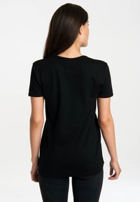Black short-sleeved t-shirt with a round neckline, smooth texture, and a fitted design, viewed from the back with a plain background.