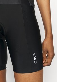 Pantaloni sportivi neri con un design aderente, realizzati in tessuto morbido, con un logo CMP bianco sulla gamba sinistra.
