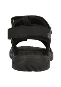 Svart sandalen med en texturerad sula, justerbara remmar och en minimalistisk design. Har robust hårdvara och ett slitstarkt material.