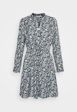 Blommig klänning med långa ärmar, V-ringad krage och insydd midja. Svart bakgrund med små lila, rosa och vita blommor.