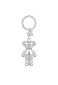 Llavero de oso de peluche plateado con una superficie suave y reflectante. Presenta orejas redondeadas, extremidades cortas y un anillo circular para su fijación.