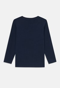 Long-sleeve navy blue T-shirt made of cotton, featuring a round neckline and unfinished hemlines. Back view displays smooth fabric texture.
