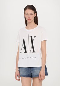 White cotton T-shirt with short sleeves, featuring a black graphic print of "AX" and "ARMANI EXCHANGE" text at the front.