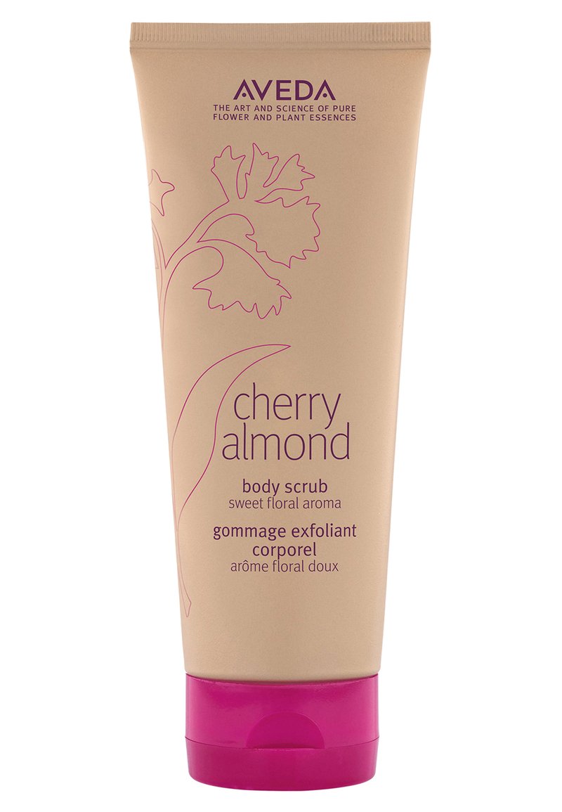 Aveda Cherry Almond body scrub in een beige knijptube met een roze dop. Bevat tekst in paars, met bloemontwerpelementen.