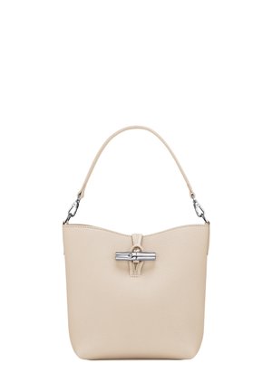 Beige textured handbag with a short handle, clasp closure, and a sleek, minimalistic design. Features a subtle logo accent on the front.