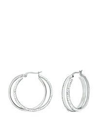 Zilverkleurige hoop oorbellen met drie cirkelvormige lagen, voorzien van heldere rhinestones langs één rand. Gladde afwerking met een gepolijste textuur.