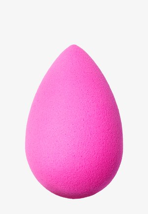 Pink makeup sponge with a teardrop shape, soft texture, and a slightly porous surface, designed for blending makeup smoothly.