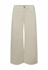 Jean beige à jambes larges avec une taille haute, comprenant une fermeture à boutons sur le devant, cinq poches et des surpiqûres visibles le long des coutures.