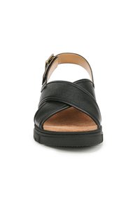 Sandali neri con design a bande incrociate, cinturino alla caviglia regolabile, soletta in sughero e suola in gomma testurizzata. Stile open-toe.