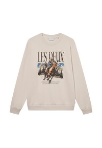 Beige színű pulóver hosszú ujjakkal, kerek nyakkivágással és elülső grafikával, amelyen egy lovas és hegyek láthatók. Puha anyag, laza fazon.