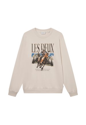 Beżowa bluza z długim rękawem, okrągłym dekoltem i grafiką z przodu przedstawiającą jeźdźca konnego oraz góry. Miękki materiał, luźny krój.