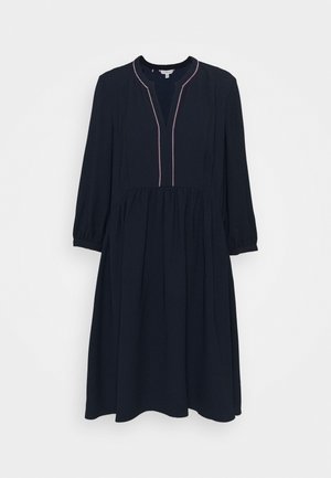 Robe midi bleu marine à manches longues, taille froncée et encolure ronde avec une petite découpe en V et un liseré blanc.