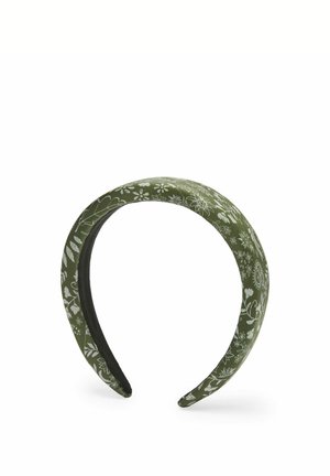 Grünes, gepolstertes Stirnband mit weißen Blumenmustern und schwarzer Innenfütterung.