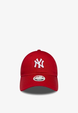 Red baseball cap with a white embroidered "NY" logo centered on the front and a curved brim with an adjustable fit sticker.